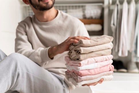 neurodivergent man folding clothes scaled