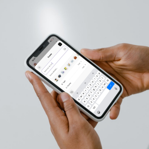 Hands holding a phone while entering a new task in Thruday with the onscreen keyboard