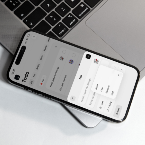 Phone resting on a laptop with Thruday’s task priority menu open