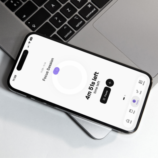 Phone resting on a laptop showing Thruday’s focus timer with 4 minutes 51 seconds remaining