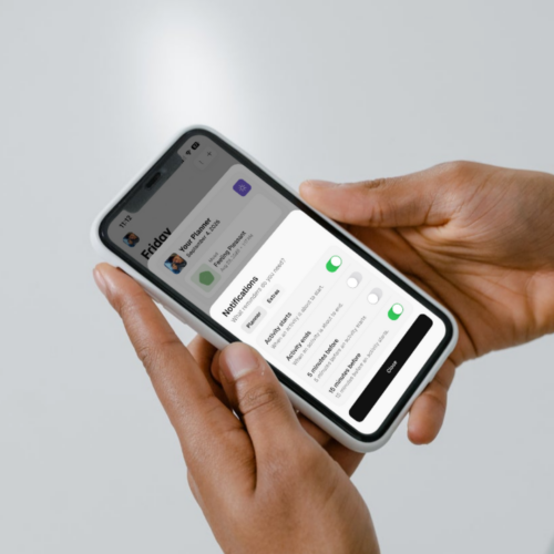 Hands holding a phone displaying Thruday’s notification settings