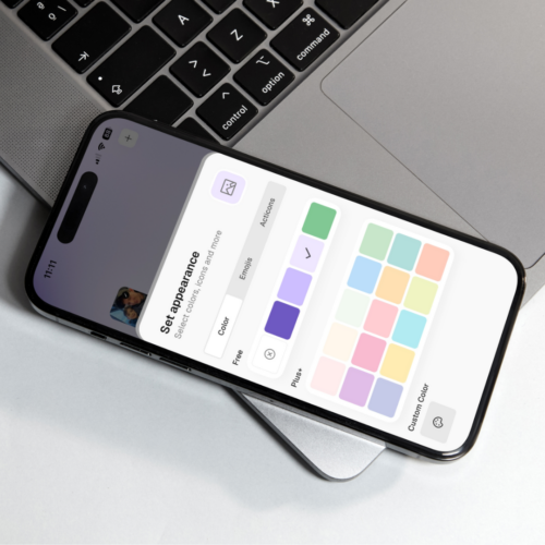 Phone resting on a laptop with Thruday’s activity colour palette open