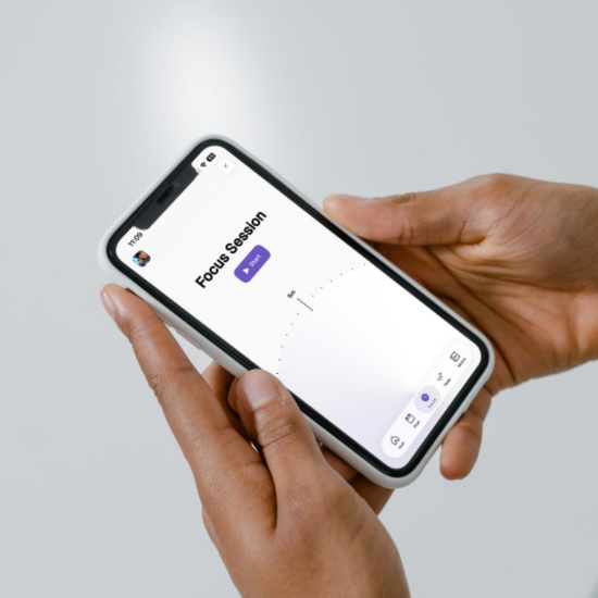 Hands holding a phone displaying Thruday’s focus session setup with a duration selector and Start button
