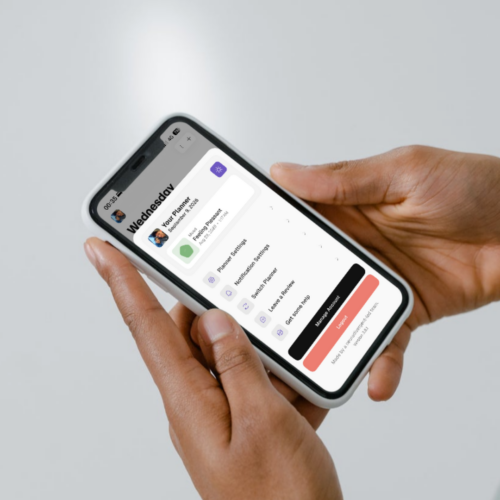Hands holding a phone displaying Thruday’s profile menu and current mood