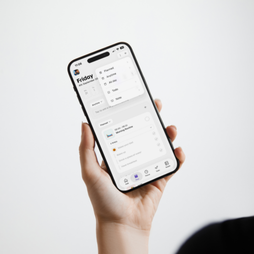 Person holding a phone displaying Thruday’s visual schedule, morning routine and activity filters